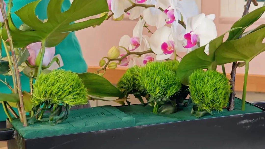 最后,我们选取金丝桃果,澳梅等小巧缤纷,生动可爱的花材点缀在绿叶