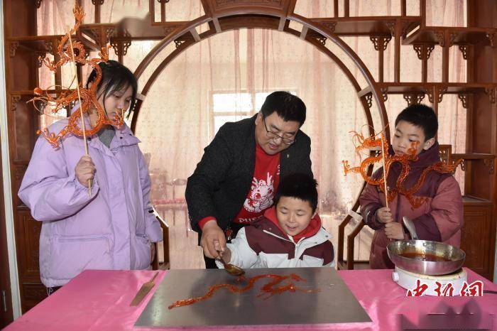 河北景县糖画艺人绘制龙形糖画感受舌尖上的非遗