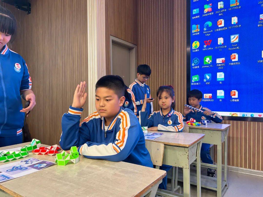 只见魔尺在一双双小手中上下翻飞,在四年级孩子们手中随意扭转,自由拼
